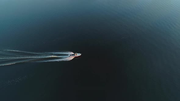 Motor Boat on River and Barge at Sunrise 