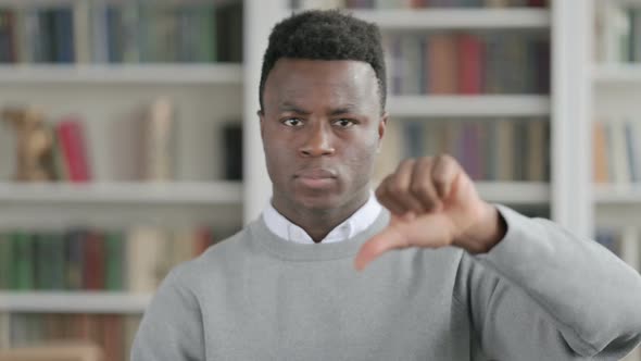 Portrait of African Man Showing Thumbs Down Gesture