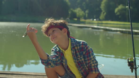 Lovely School Age Arab Boy Learning About Fishing Tackle During Fishing on Pond