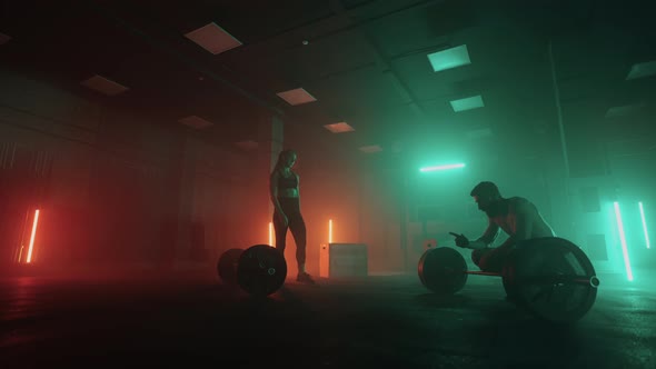 Team of Powerlifters or Bodybuilders in Gym Man and Woman are Training Together