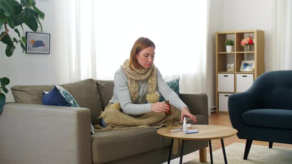 Sick Woman in Scarf Drinking Cough Syrup at Home