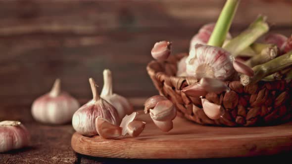 Super Slow Motion Garlic Falls on a Wooden Background