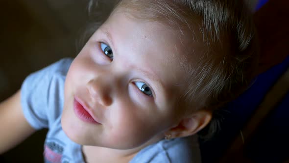 Face of a Beautiful Little Girl Whose Mom Braids a Braid