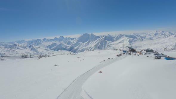 Aerial View Ski Track of Snow Mountain Slope at Natural Landscape Clear Blue Sky