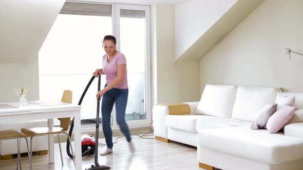 Woman or Housewife with Vacuum Cleaner at Home 