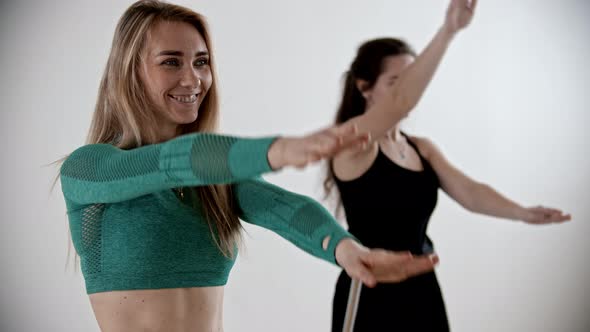 Two Sportive Women Warming Up at Fitness Training - Moving Their Hands