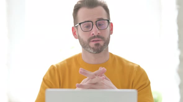 Portrait of Man Talking on Video Call on Laptop