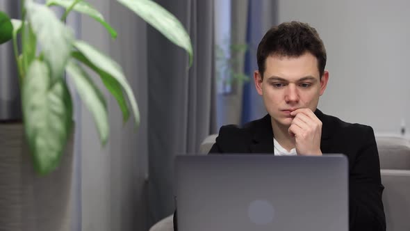 Student Looks at Laptop Screen Display Celebrating Admission to University