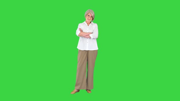Business Lady Standing with Crossed Hands on a Green Screen Chroma Key