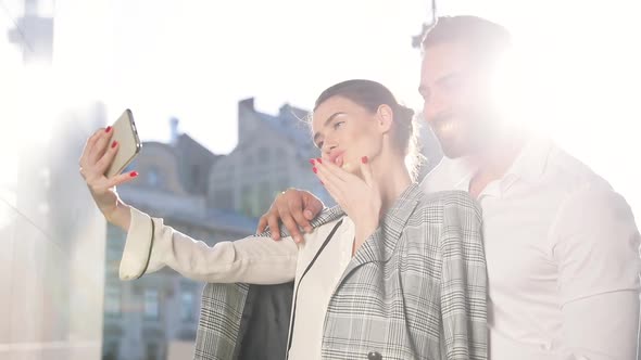 Happy Couple Making Photo On Phone Outdoors