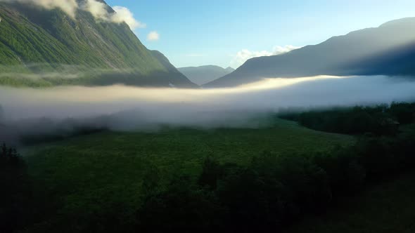 Morning Mist Over the Valley Among the Mountains in the Sunlight