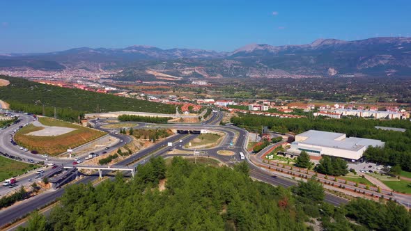 Aerial Panoramic View of a Mountain Valley with City Road and Infrastructure