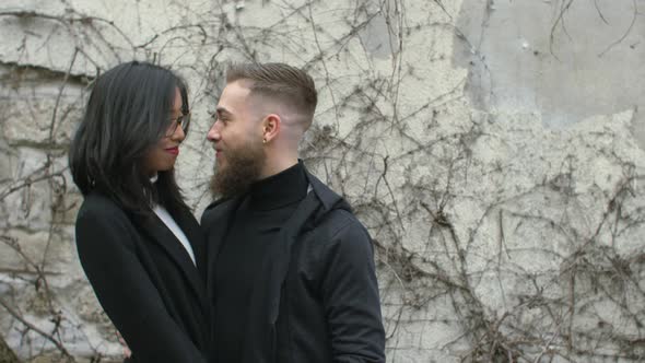 Man and woman on the street looking each other