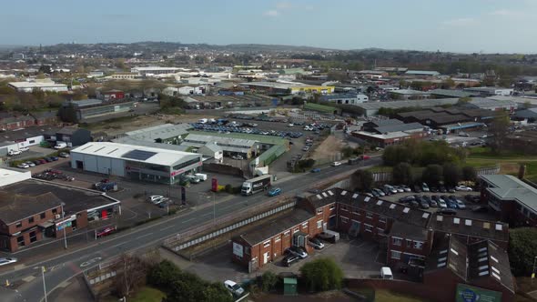 Aerial drone panning across rural village houses and supermarket, Essex England