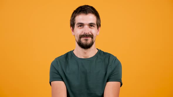 Attractive Bearded Man Smiles at the Camera Then Shows a Toy Airplane in the Frame