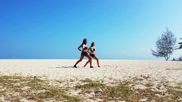 Modern beauty models on vacation enjoying life on beach on sunny blue and white sand background 4K