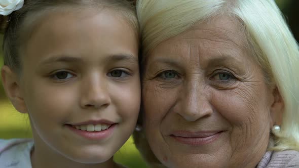 Grandmother and Granddaughter Looking in Camera, Generation, Faces Closeup