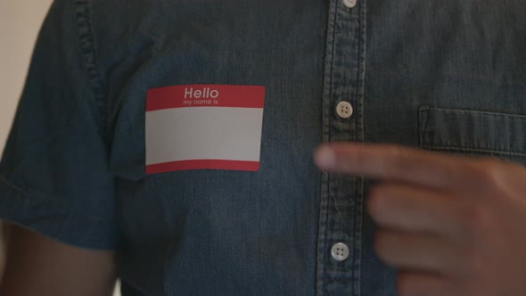 Close Up of a Man Pointing to a Blank Name Tag