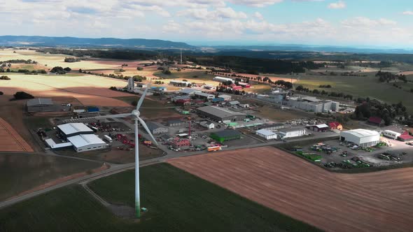 Rotating wind turbine against industrial plants and factories