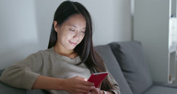 Woman use of mobile phone at home