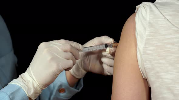 doctor or nurses are vaccination to patient using the syringe injected upper arm