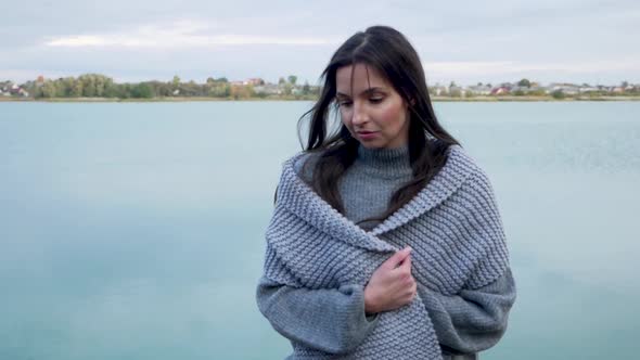 Girl with Long Hair and a Gray Sweater with a Scarf