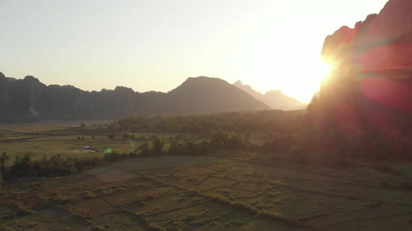 Aerial: Vang Vieng backpacker travel destination in Laos, Asia. Sunset scenic cl