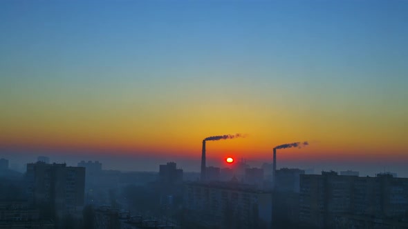 Dawn in the City With Smoking Pipes. Time Lapse