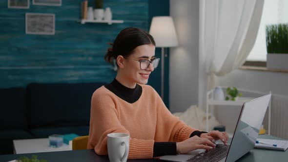 Young Adult Taking Notes on Laptop at Online School Class