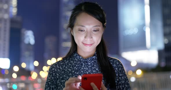 Young Businesswoman use of mobile phone in city at night