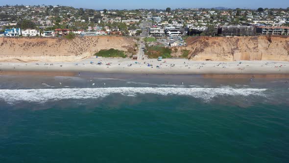 Drone shot flying towards Solana Beach and coastal city in San Diego, America