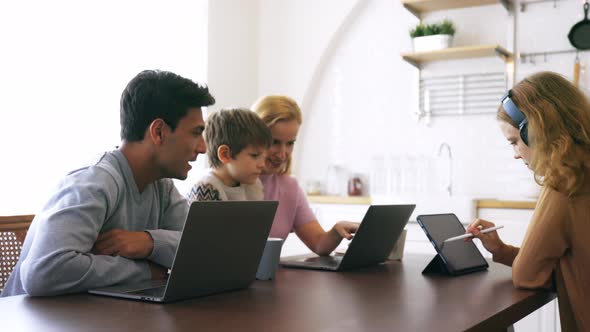 Happy Family Using Electronic Device at Home