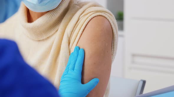 Nurse with Syringe Making Injection to Woman