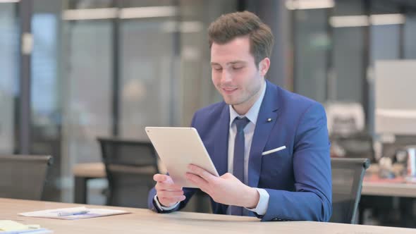 Businessman Making Video Call on Tablet in Office