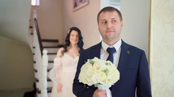 the Bride Approaches the Groom From Behind and Closes His Eyes