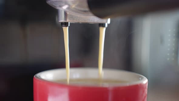 4k Slow motion B Roll of Pouring coffee stream from machine in cup.