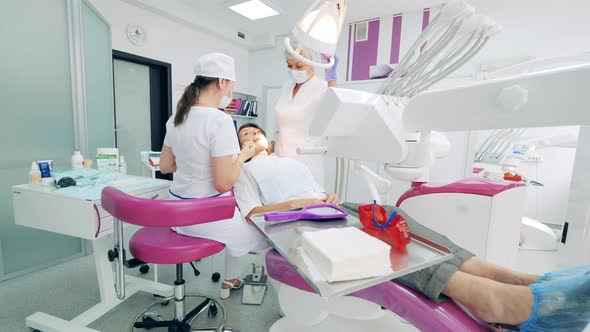 Dentists are Treating a Patient in the Clinic