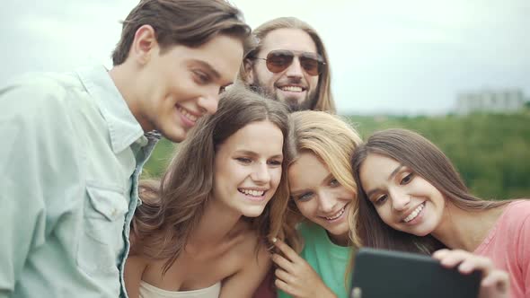 Friends Having Fun And Taking Photos In Nature