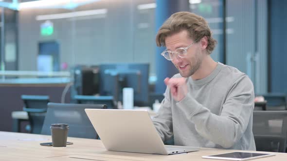 Young Businessman Talking on Video Call on Laptop