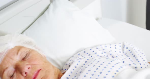 Senior woman patient sleeping on bed