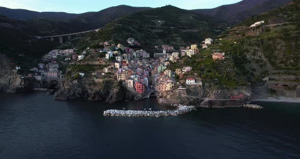 Aerial pullback reveals charming Riomaggiore on Cinque Terre, Italy