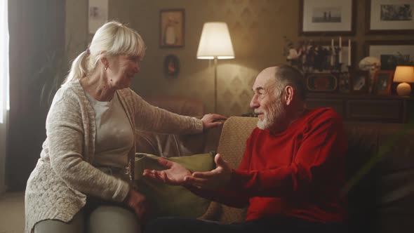 Aged Couple Sharing Funny Stories in Living Room