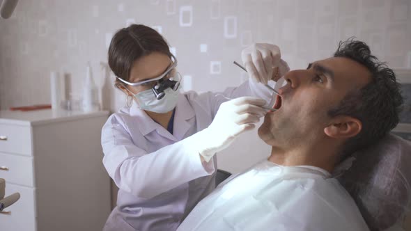 Dentist treats patient's teeth.