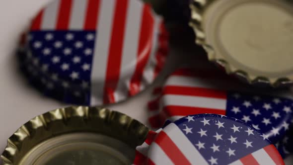 Rotating shot of bottle caps with the American flag printed on them - BOTTLE CAPS