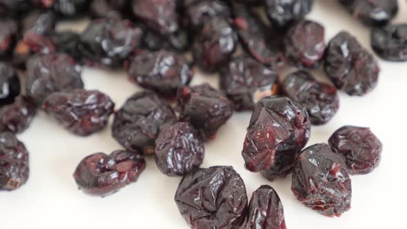 Dehydrated cranberries on pile close-up 4K 2160p 30fps UltraHD tilting footage - Vaccinium oxycoccos