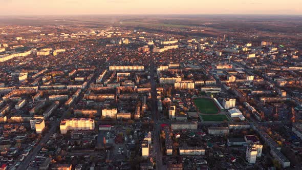 Flying Over City At Sunset