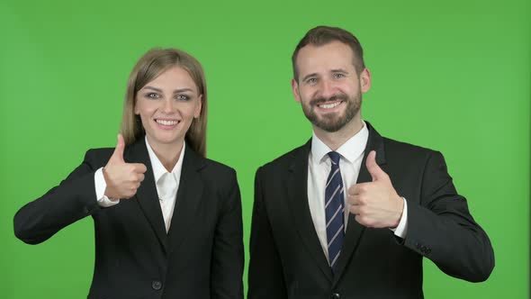 Male and Female Business Professionals Speaking Toward Camera Against Chroma Key