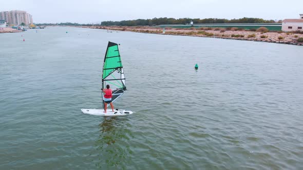 Athletic Man Windsurfing On A Deep Ocean In Benidorm Spain  Extreme Water Sport