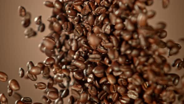 Super Slow Motion Shot of Crashing Coffee Beans on Brown Gradient Background at 1000Fps