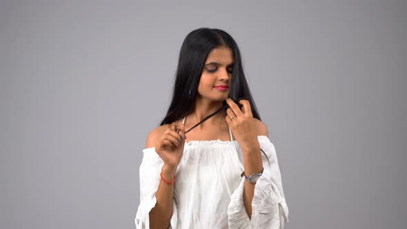 Happy Indian girl playing with hairs